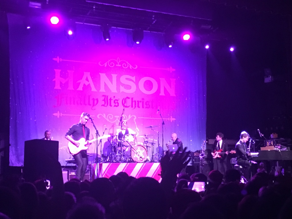 Hanson performing onstage